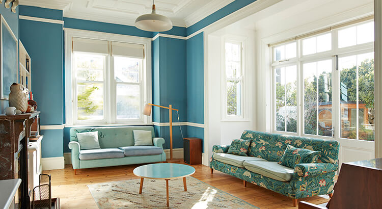 Bright Airy Livingroom with Blue Walls and Wood Floors