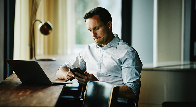 Businessman looking at smartphone in office