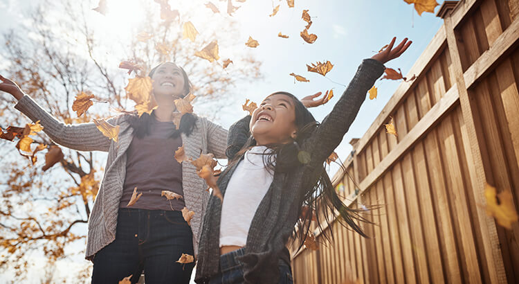 Mom and Daughter Playing in the Fall Leaves