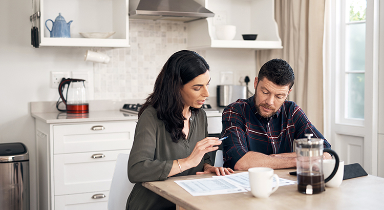 Shot of a young couple going over their finances together at home