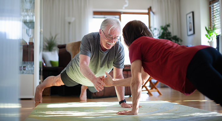 Senior couple exercising at home