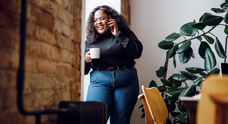 Happy woman laughing during a phone call